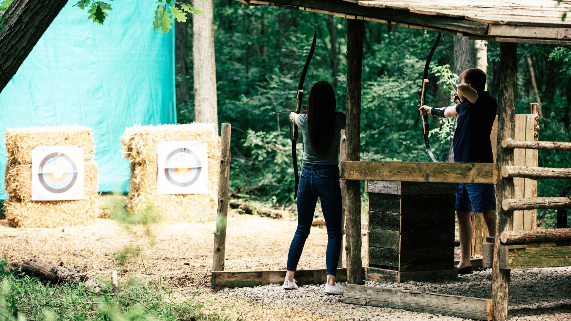 Two people practicing archery.