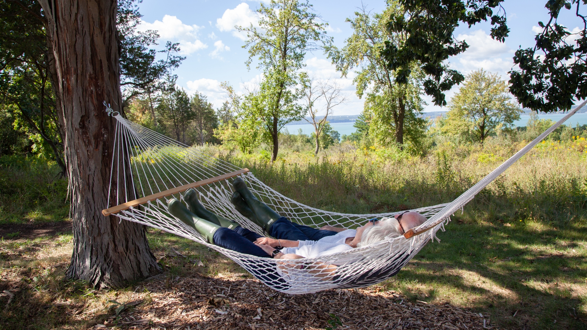 Couple resting on a hammock.