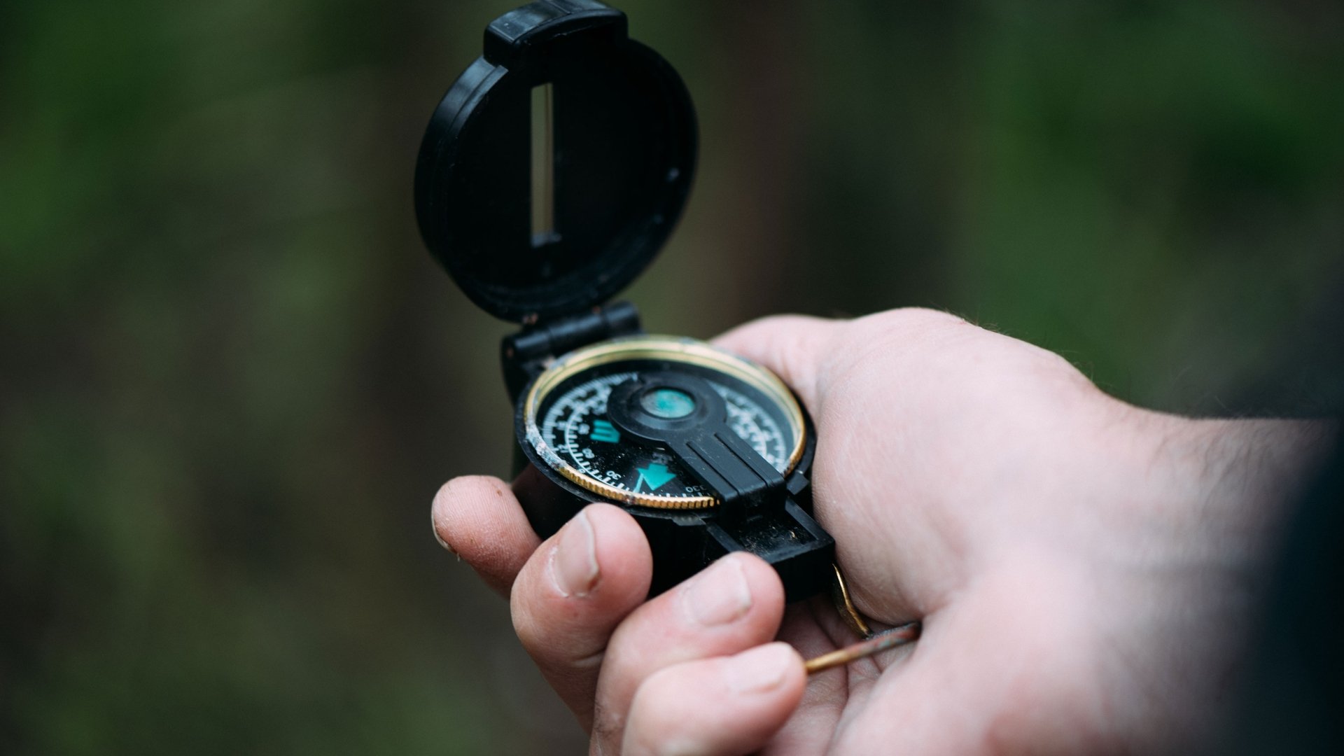 Person holding compass.