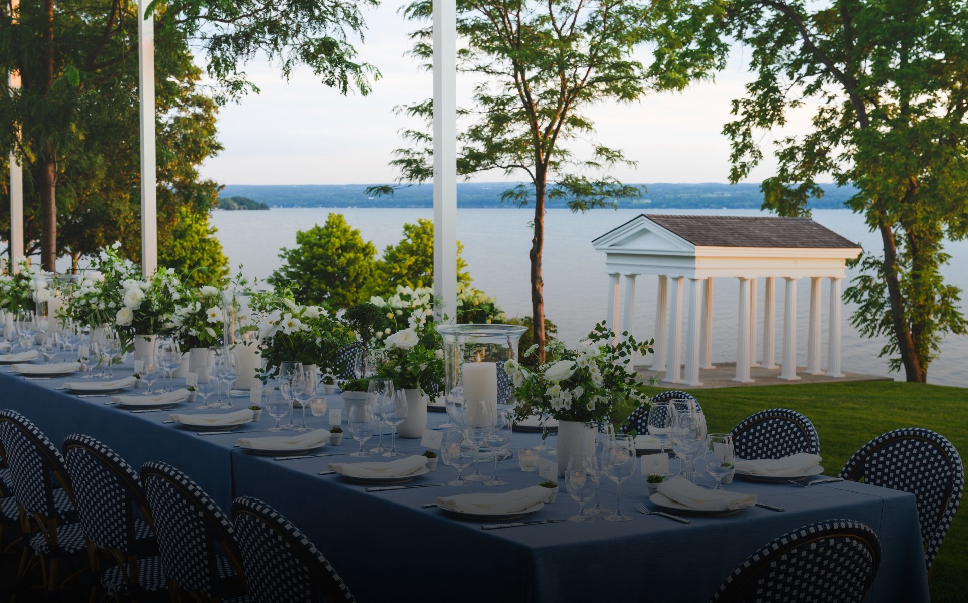 Wedding reception setup with long table blue chairs.