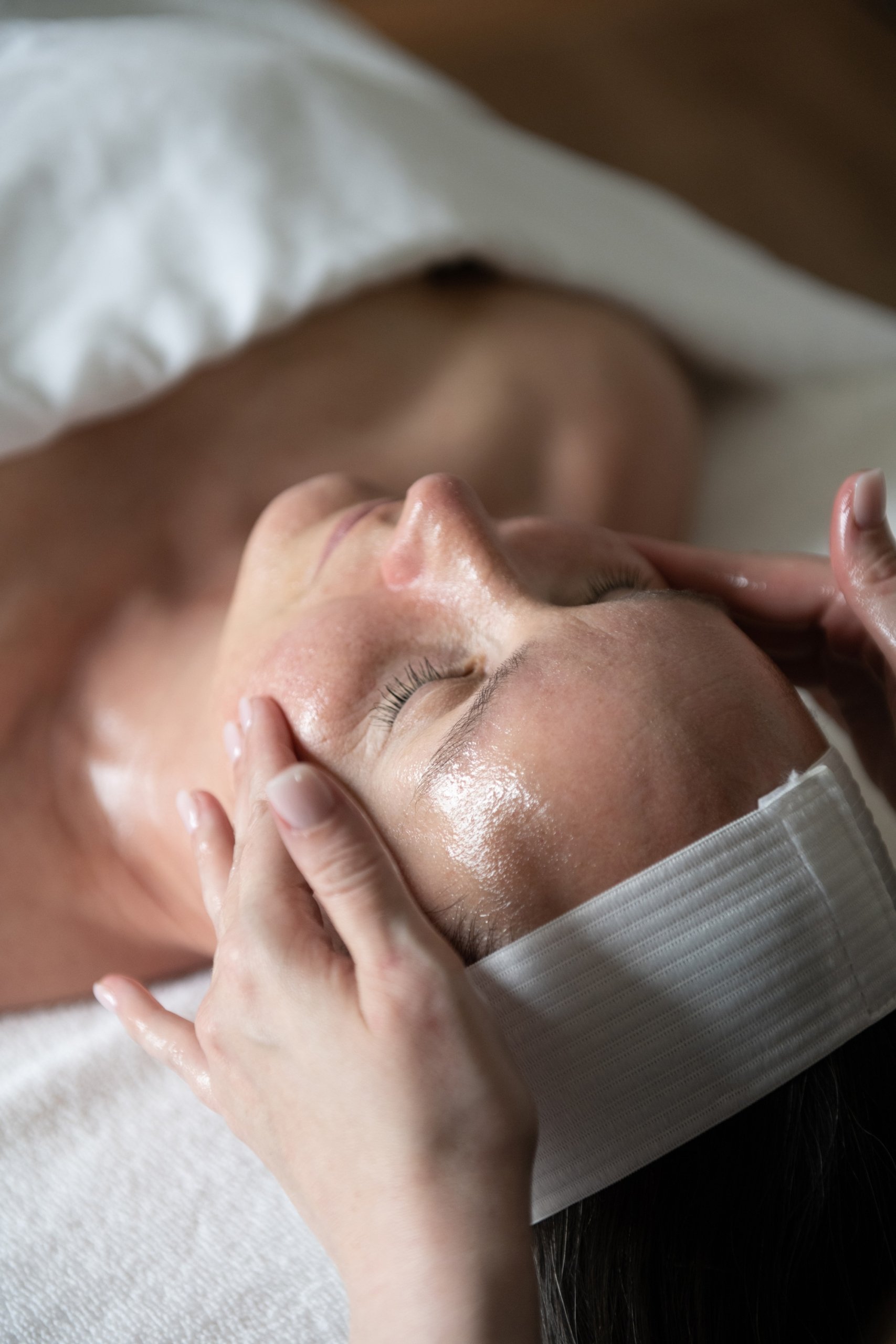 Client getting a relaxing facial at The Spa at Inns of Aurora.