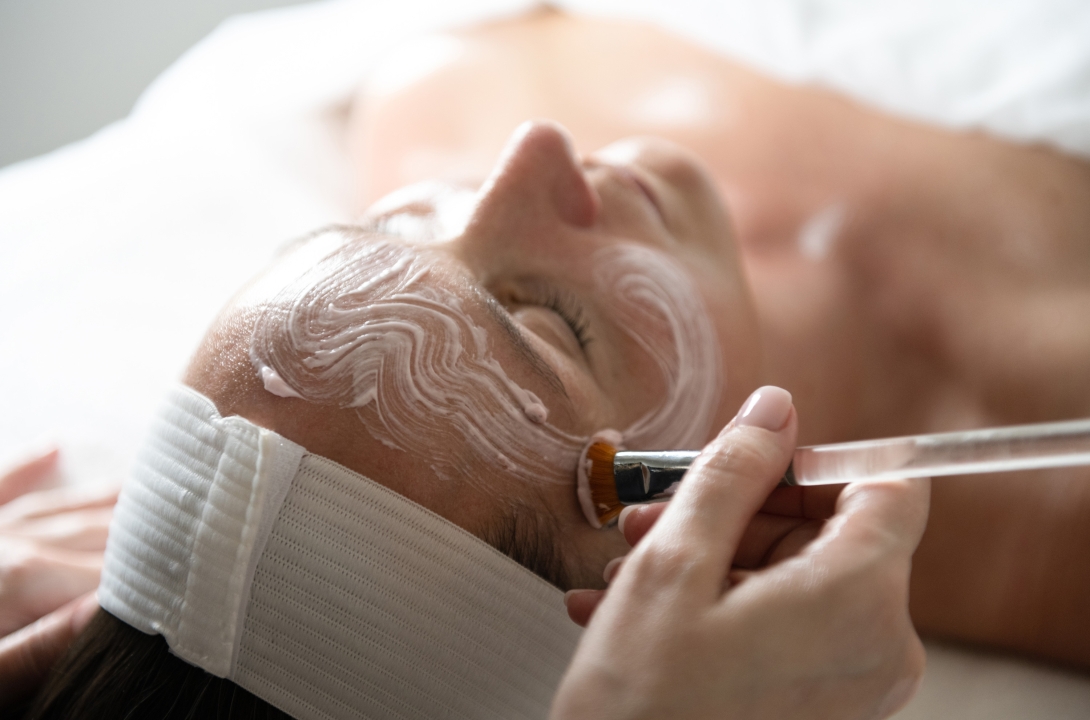 A woman receiving a relaxing facial treatment at The Spa at Inns of Aurora.