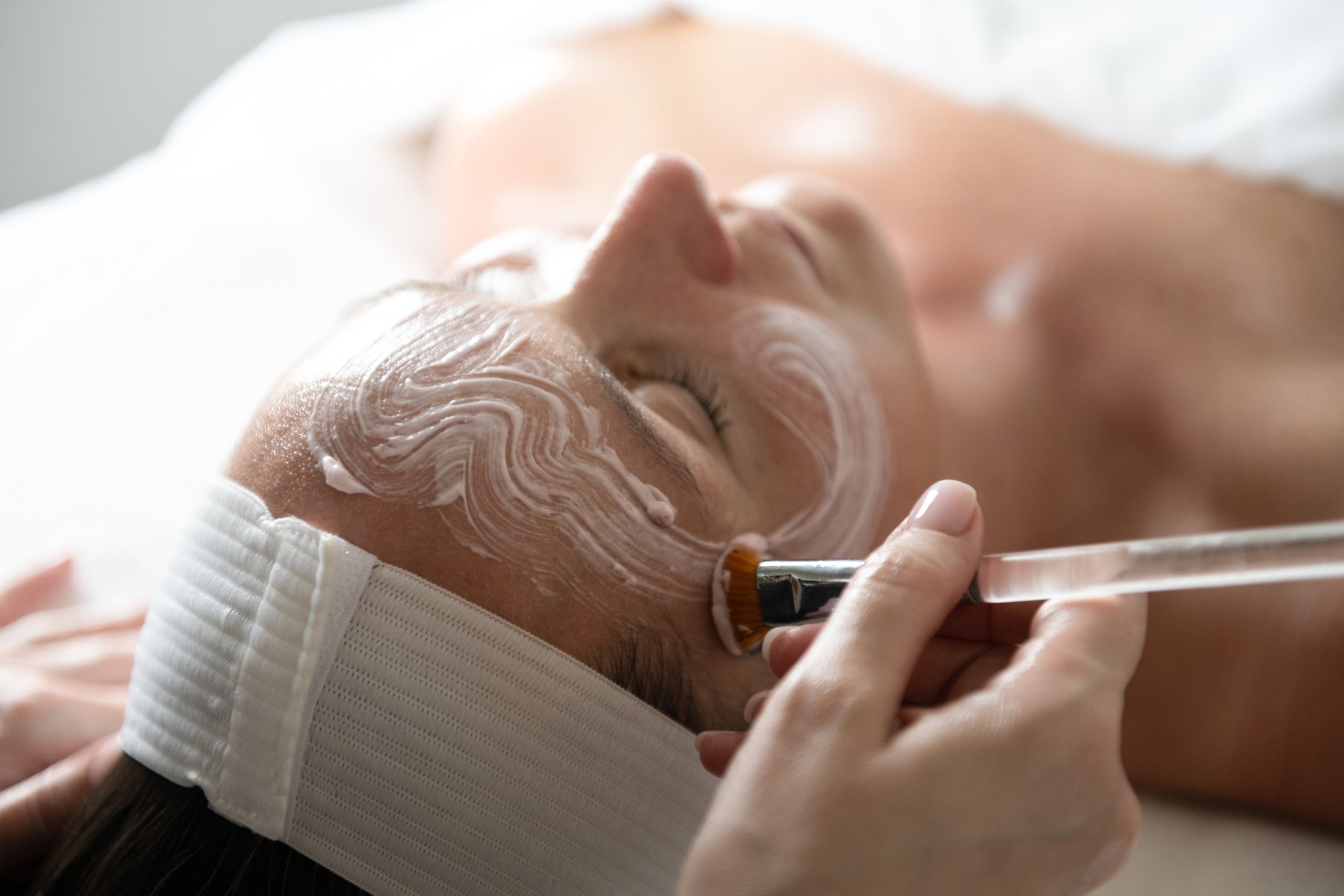 A woman receiving a relaxing facial treatment at The Spa at Inns of Aurora.