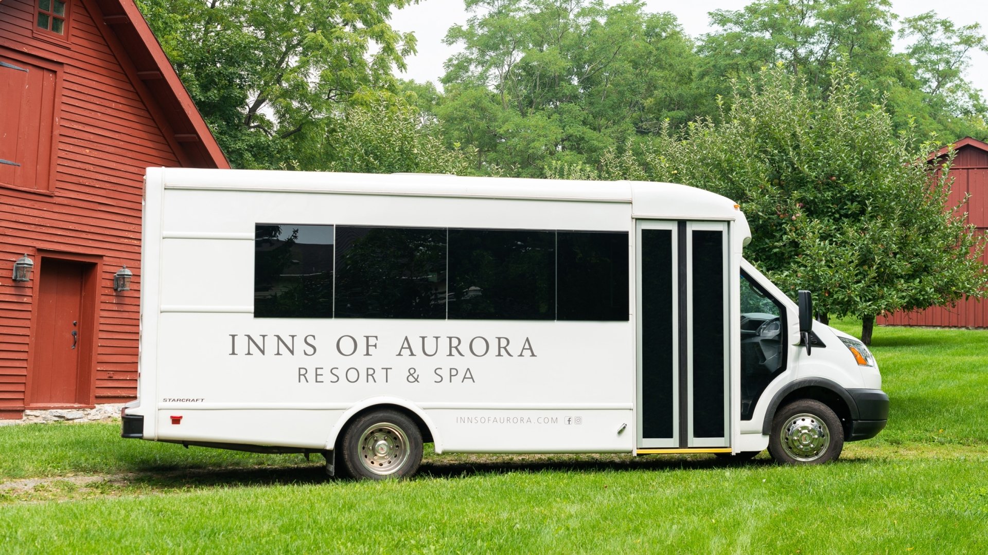 Inns of Aurora white shuttle bus.