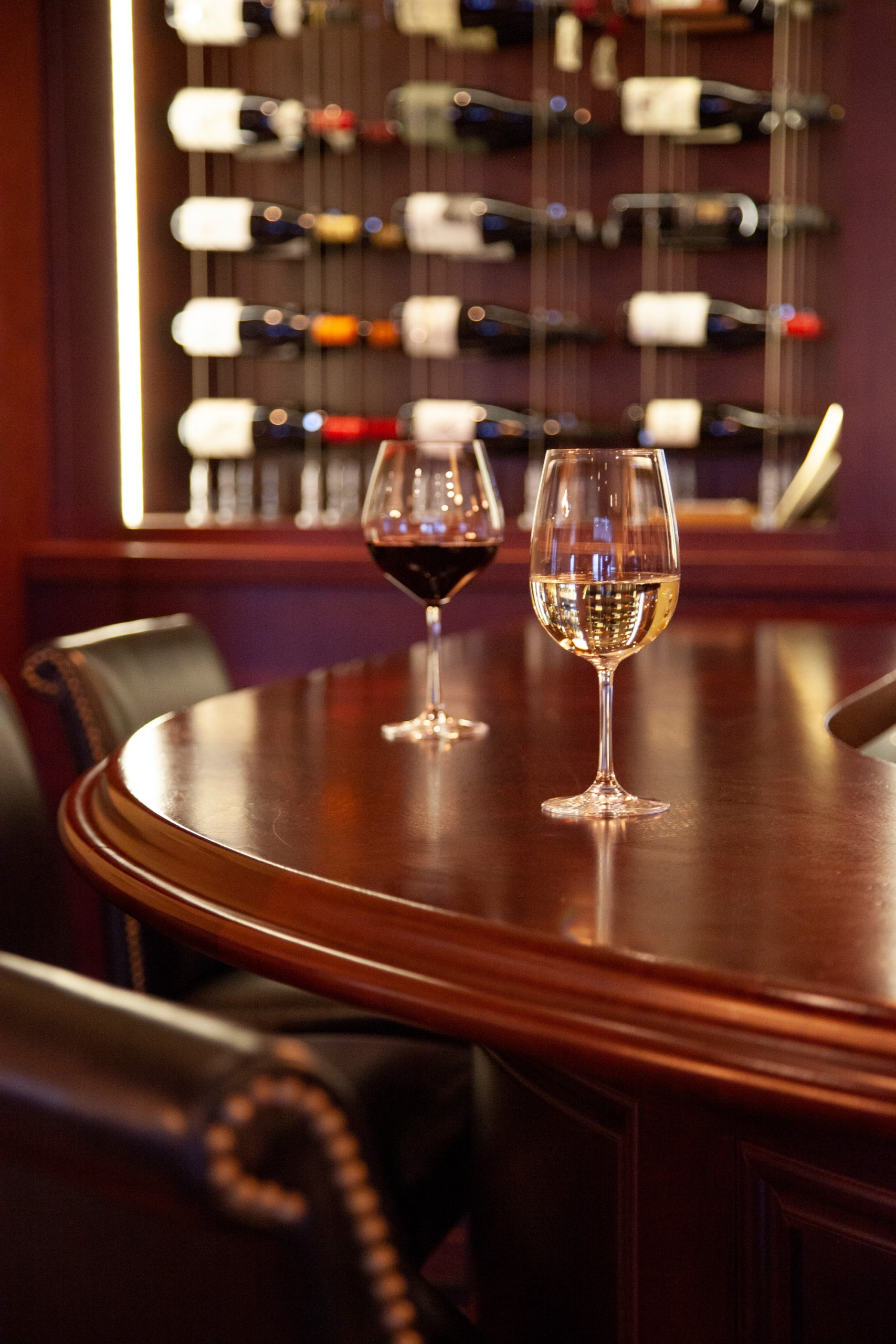 Two glasses of wine on round table at 1833 Kitchen & Bar.