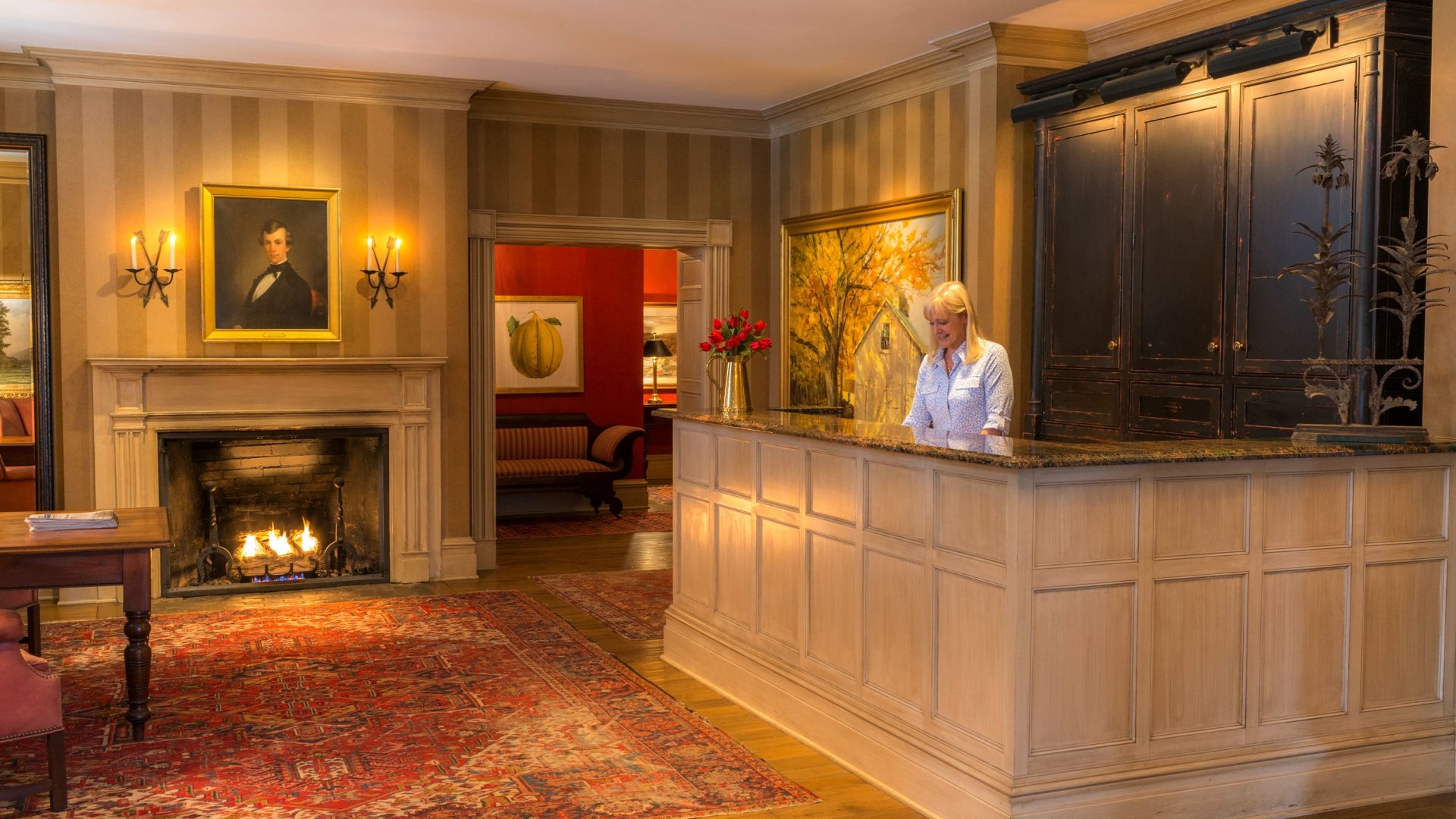 Employee working at the front desk at Inns of Aurora.