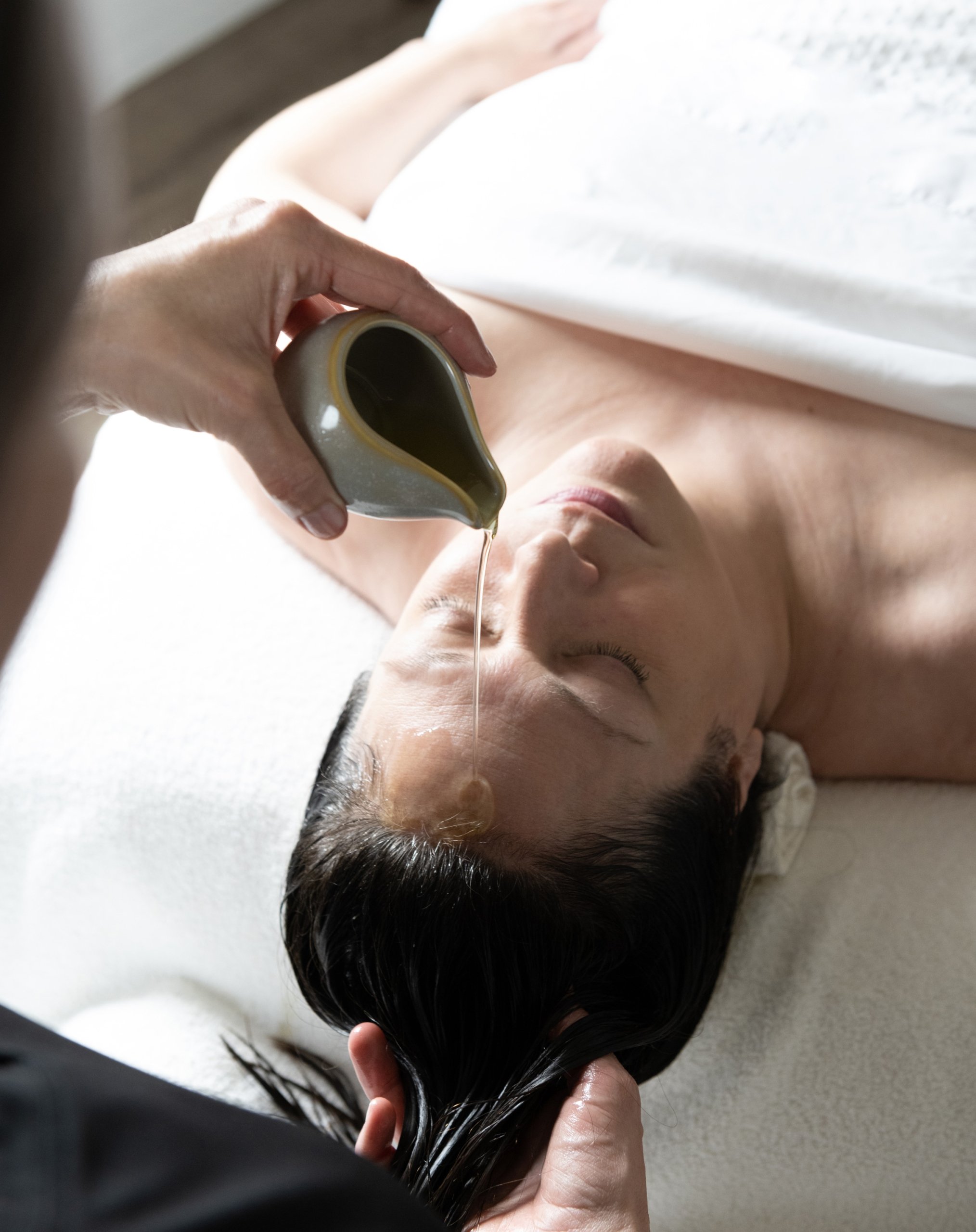 A woman receiving a facial treatment at The Spa at Inns of Aurora.