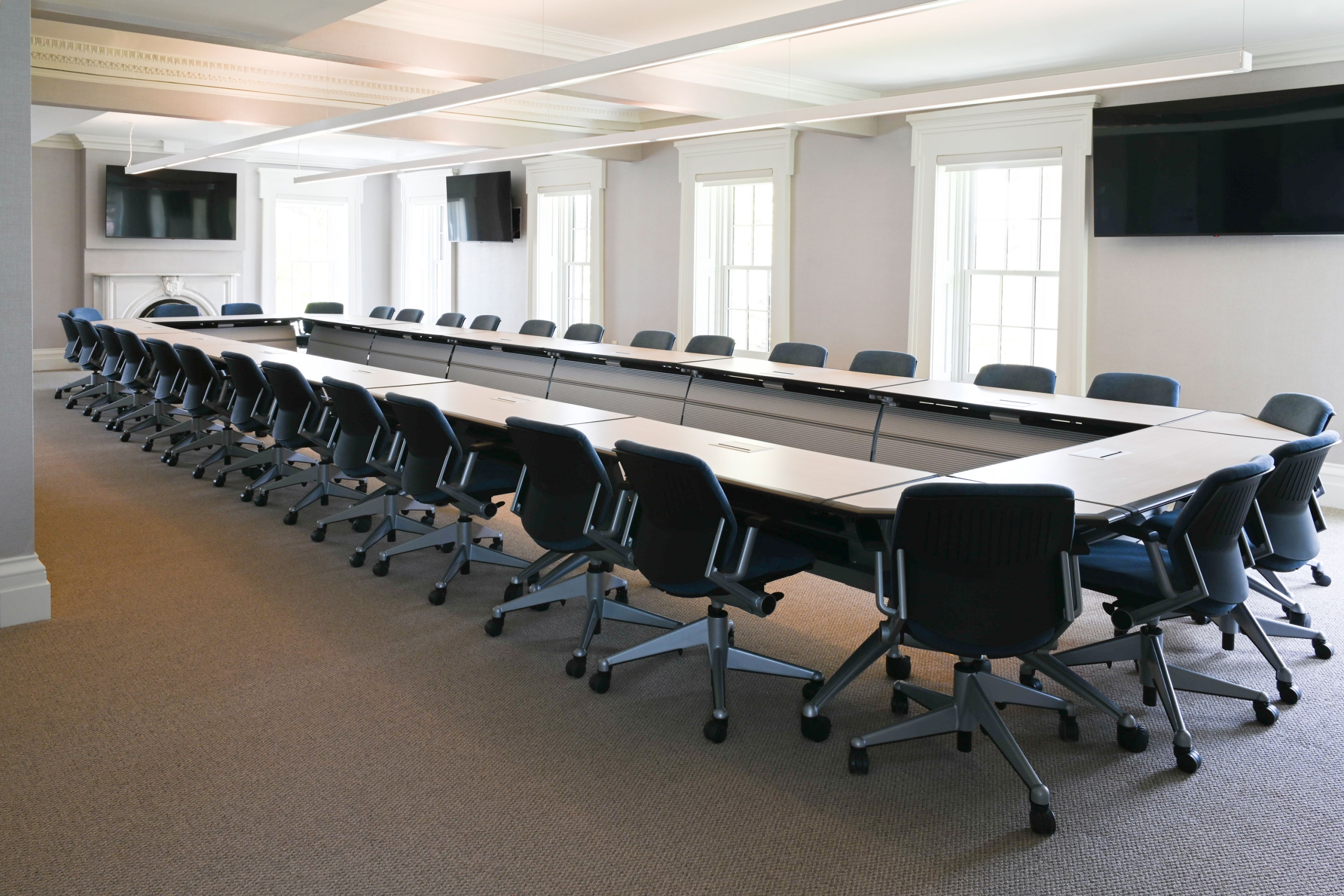 Large conference table surrounded with chairs in the Taylor House boardroom.